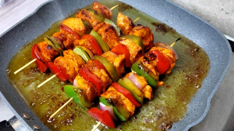 Grilling chicken and vegetable skewers